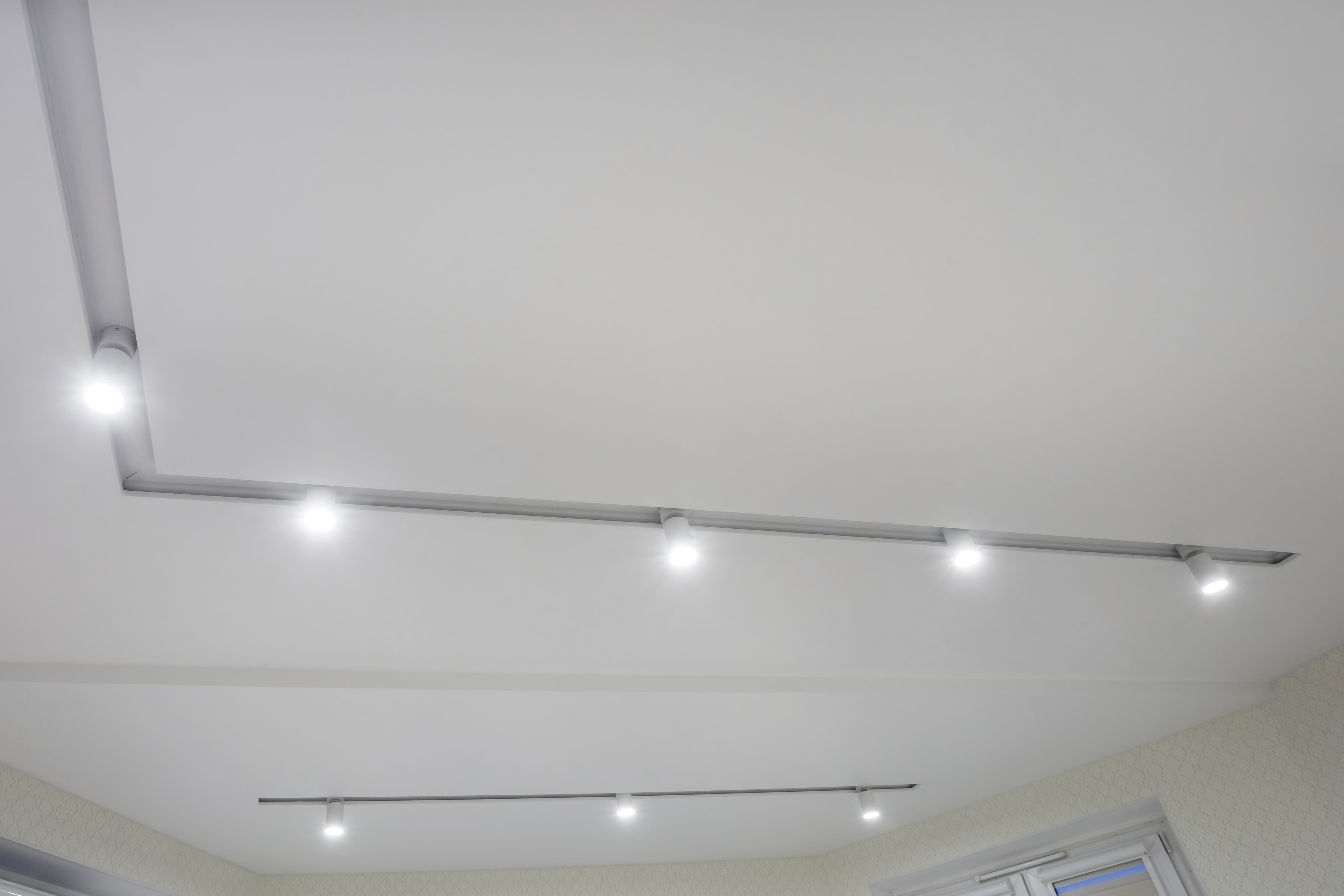 suspended-ceiling-with-halogen-spots-lamps-drywall-construction-empty-room-apartment-house-stretch-ceiling-white-complex-shape-copy.jpg